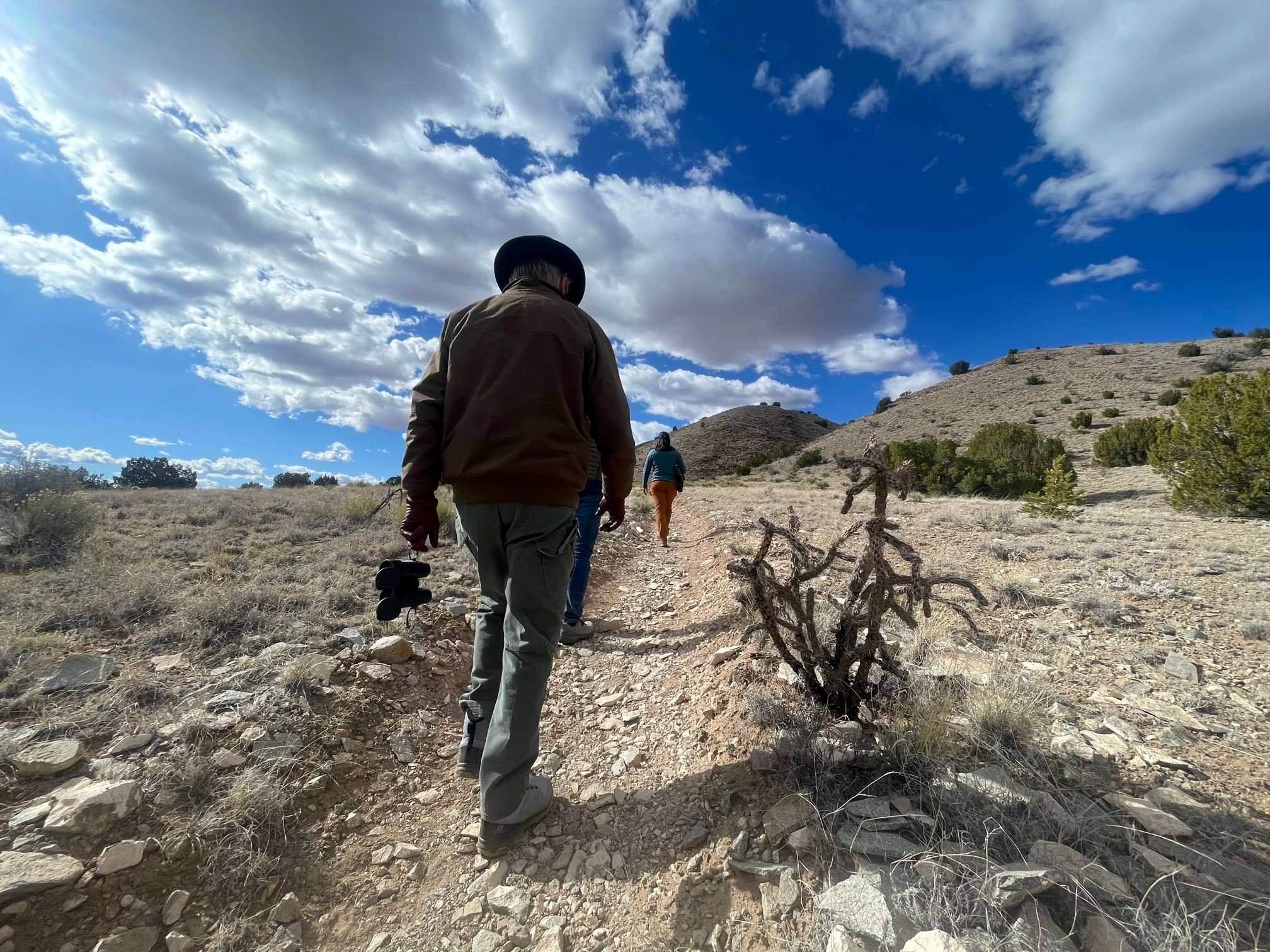 People walk on a trail at 10 Little Hills, a Santa Fe County Open Space property near Cerrillos Hills State Park.