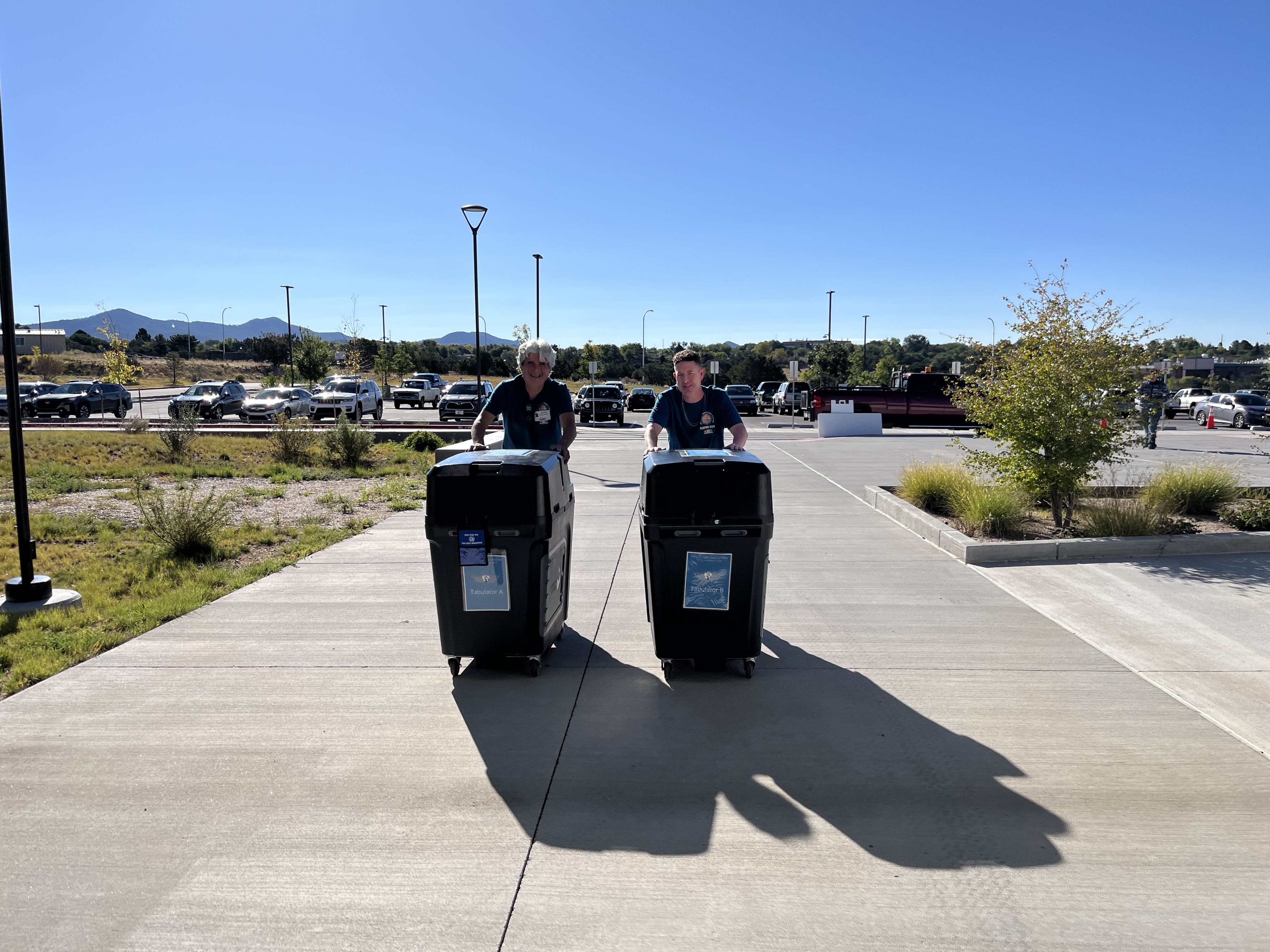 Election staff bringing tabulators